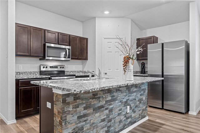 960 Chambray Dr, Troy, TX 76579 - kitchen with a sink, dark brown cabinets, light wood finished floors, and stainless steel appliances