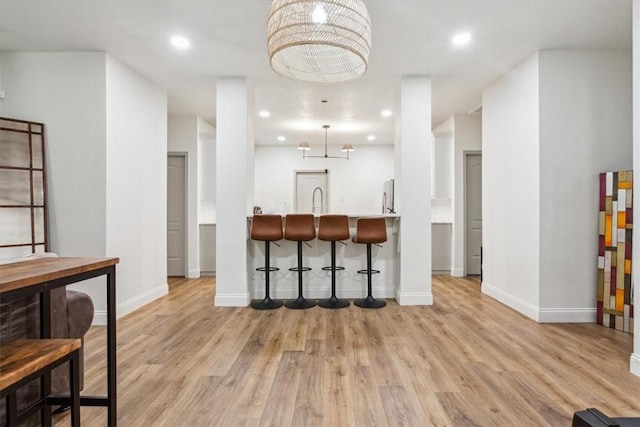 629 S 5th St, Waco, TX 76706 - kitchen featuring recessed lighting, a kitchen bar, baseboards, and light wood finished floors
