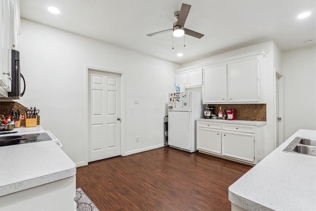 629 S 5th St, Waco, TX 76706 - kitchen with dark wood-type flooring, white cabinetry, freestanding refrigerator, light countertops, and decorative backsplash