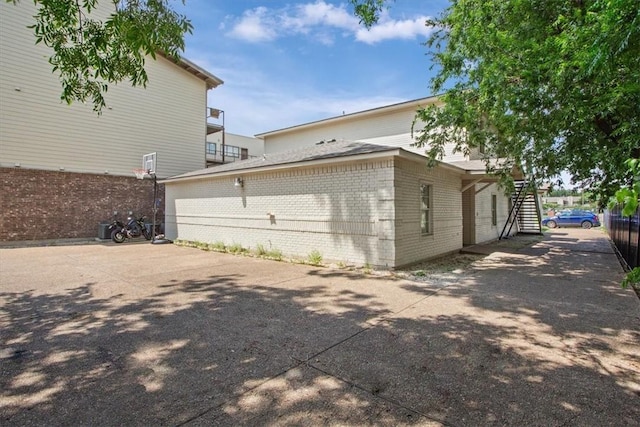 629 S 5th St, Waco, TX 76706 - view of home's exterior with stairway, brick siding, and driveway