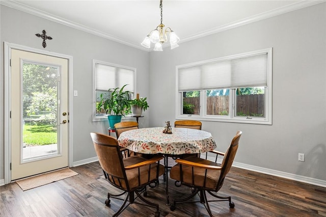dining room featuring dark wood-style flooring, baseboards, a notable chandelier, and ornamental molding