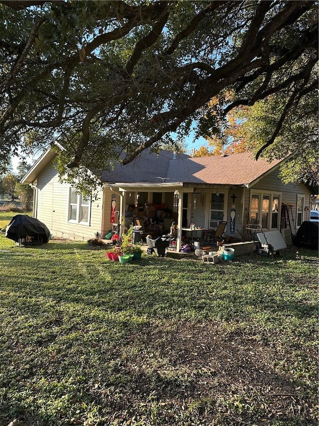rear view of house featuring a patio area and a lawn