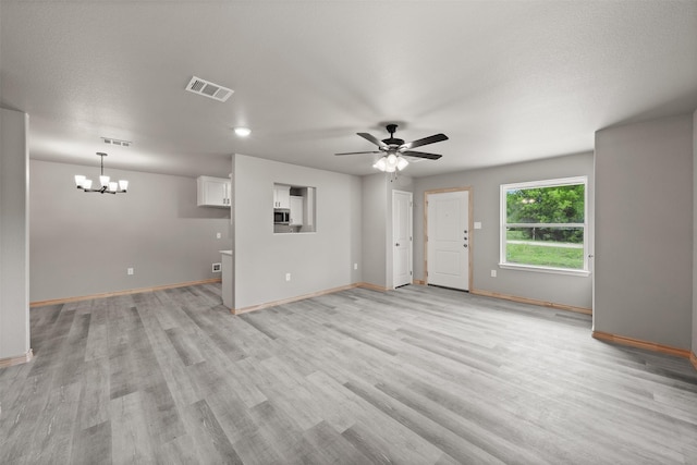 unfurnished living room with visible vents, light wood-style floors, and baseboards