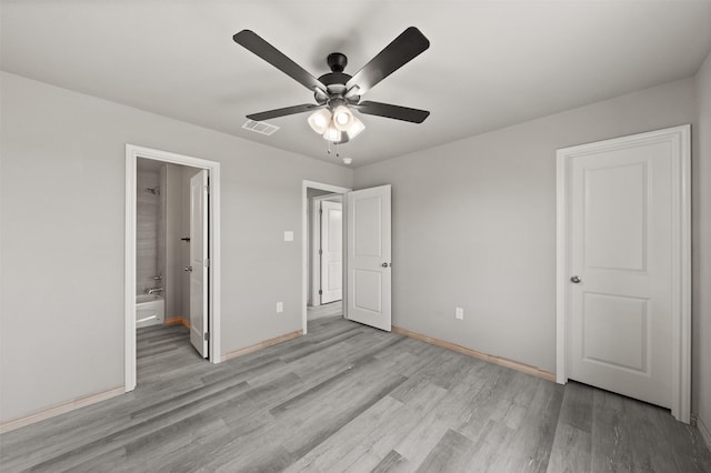 unfurnished bedroom with connected bathroom, baseboards, visible vents, and light wood finished floors