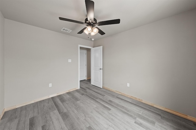 unfurnished room with visible vents, baseboards, ceiling fan, and wood finished floors