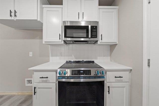 kitchen with light countertops, white cabinetry, appliances with stainless steel finishes, and tasteful backsplash