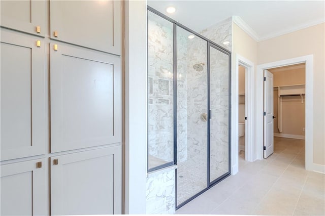 full bathroom featuring baseboards, a shower stall, crown molding, toilet, and tile patterned floors