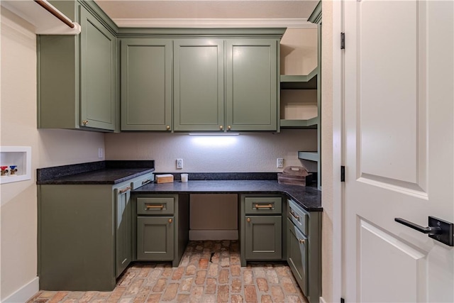 kitchen featuring dark countertops, brick floor, and green cabinetry