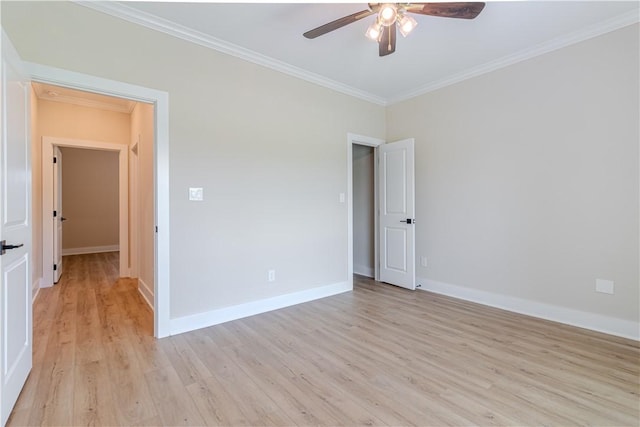 empty room featuring light wood-type flooring, baseboards, ceiling fan, and crown molding