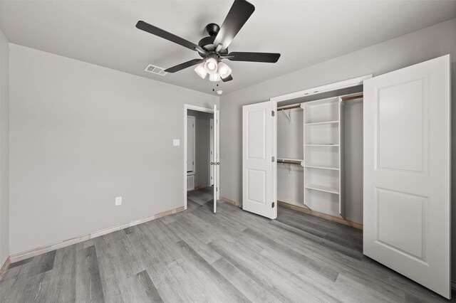 unfurnished bedroom featuring a closet, visible vents, baseboards, a ceiling fan, and light wood-style flooring