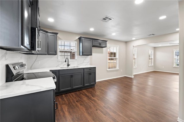 2713 Woodrow St, Waco, TX 76708 - kitchen featuring a sink, dark wood-type flooring, stainless steel microwave, open floor plan, and light stone countertops