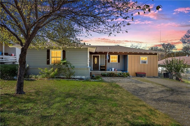 511 N Abbott St, Hillsboro, TX 76645 - ranch-style house with gravel driveway, a porch, a yard, and board and batten siding
