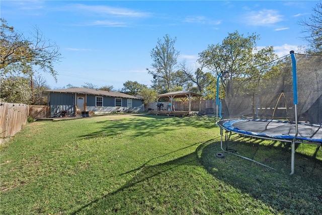 511 N Abbott St, Hillsboro, TX 76645 - view of yard featuring entry steps, a gazebo, a trampoline, and a fenced backyard