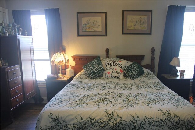 bedroom with dark wood finished floors