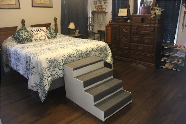 bedroom with dark wood finished floors