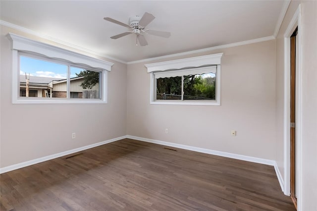 unfurnished room featuring ceiling fan, baseboards, dark wood finished floors, and crown molding