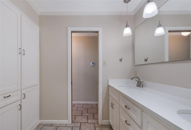 full bathroom with baseboards, double vanity, ornamental molding, a sink, and stone finish flooring