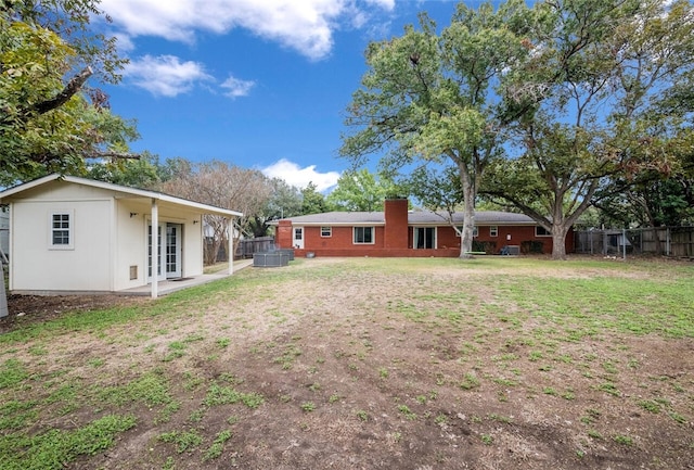 view of yard featuring french doors and fence