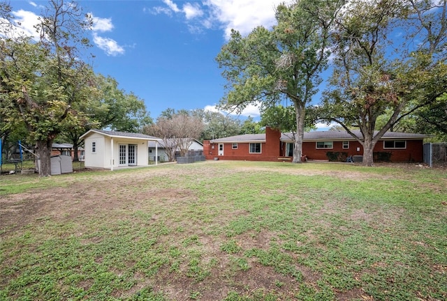 view of yard featuring an outbuilding and fence