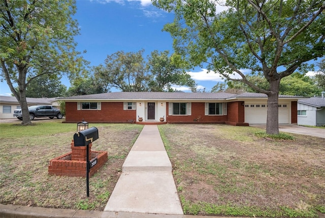 ranch-style home featuring brick siding, an attached garage, driveway, and a front lawn