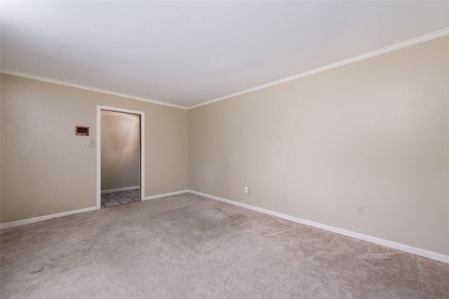 unfurnished room with baseboards, light carpet, and ornamental molding