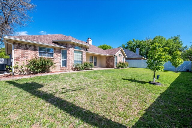 1110 Springhill St, Waco, TX 76705 - ranch-style house with a patio, brick siding, a front yard, and fence