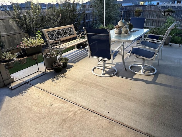 wooden terrace with outdoor dining space and fence