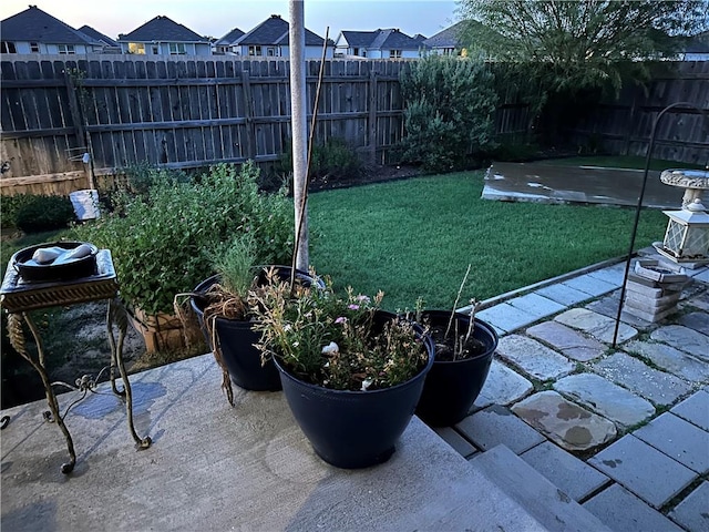 view of yard with a patio area, fence, and a residential view