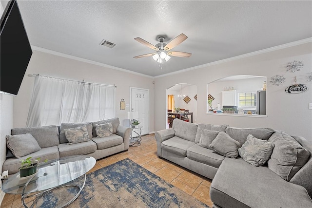 820 Carver St, Waco, TX 76704 - living room with light tile patterned floors, a ceiling fan, visible vents, arched walkways, and ornamental molding