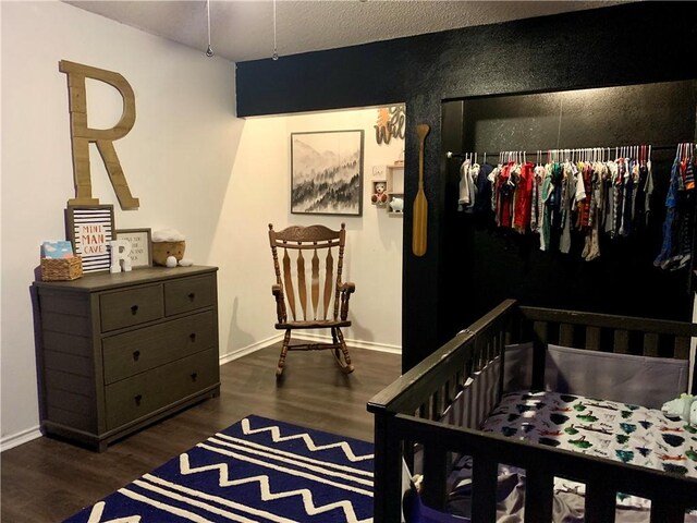bedroom featuring dark wood finished floors and baseboards