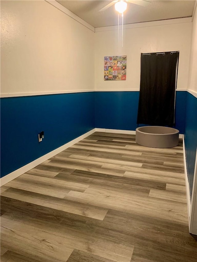 707 Cherry Dr, Groesbeck, TX 76642 - empty room featuring wood finished floors, a ceiling fan, baseboards, and ornamental molding