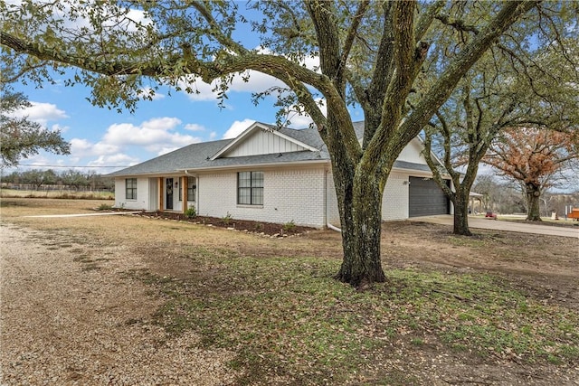 single story home with brick siding, an attached garage, concrete driveway, and a shingled roof