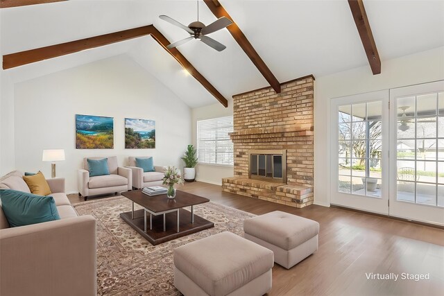 unfurnished living room with high vaulted ceiling, wood finished floors, ceiling fan, baseboards, and beam ceiling