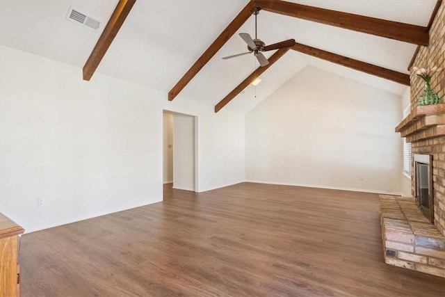 unfurnished living room featuring visible vents, beamed ceiling, a ceiling fan, wood finished floors, and a fireplace