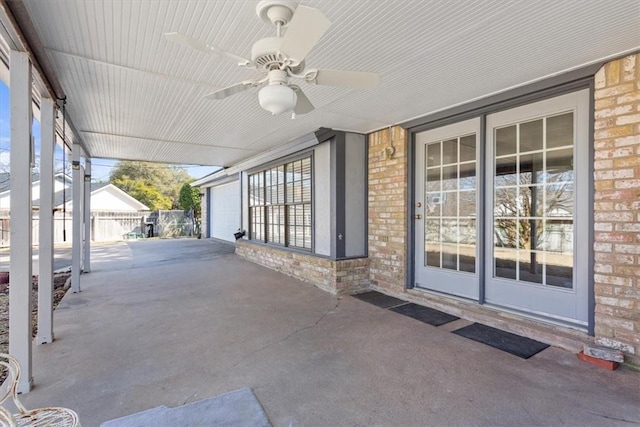 view of patio / terrace with a ceiling fan and a garage