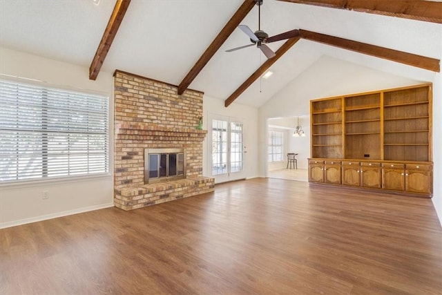unfurnished living room with wood finished floors, beam ceiling, baseboards, high vaulted ceiling, and ceiling fan with notable chandelier