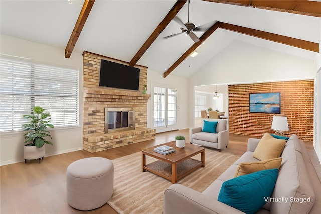 living room featuring wood finished floors, a wealth of natural light, and a ceiling fan