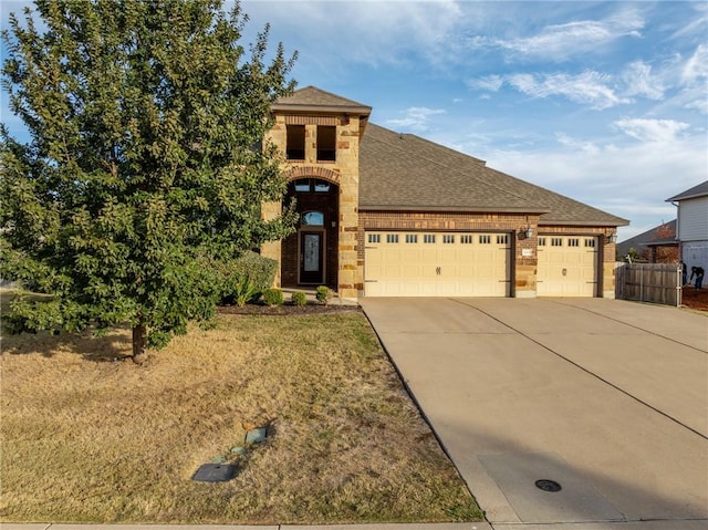 view of front of house featuring a garage, brick siding, driveway, and a shingled roof