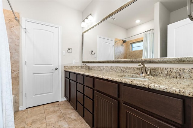 bathroom featuring double vanity, a shower with curtain, visible vents, and a sink