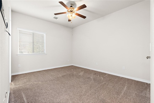 carpeted empty room featuring visible vents, baseboards, and ceiling fan