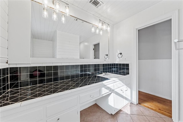 bathroom featuring visible vents, a wainscoted wall, wooden ceiling, and tile patterned flooring