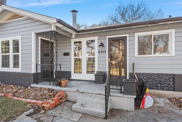 doorway to property featuring brick siding