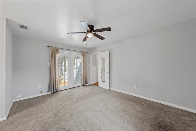 spare room featuring visible vents, baseboards, carpet, french doors, and a ceiling fan