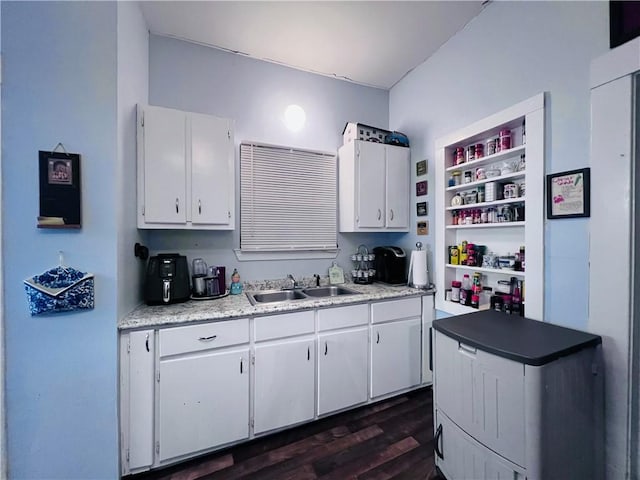 kitchen featuring a sink, open shelves, dark wood-type flooring, and white cabinets