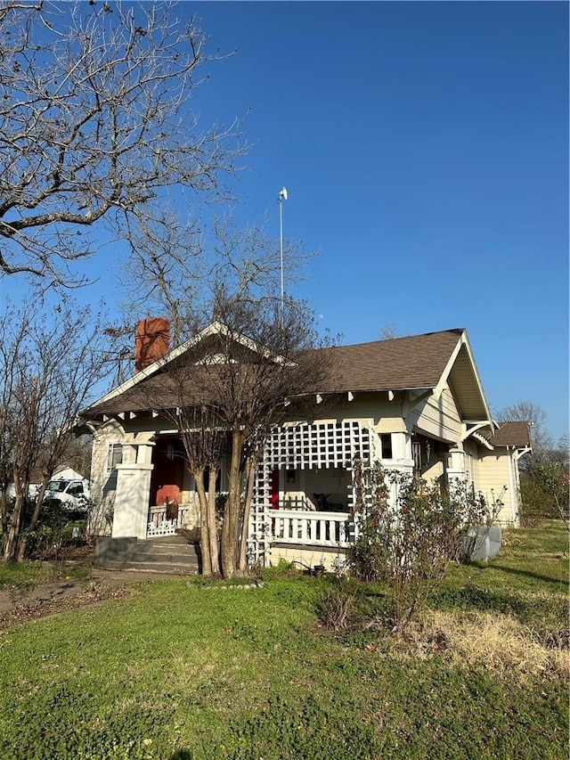 view of front of house with a chimney and a front yard