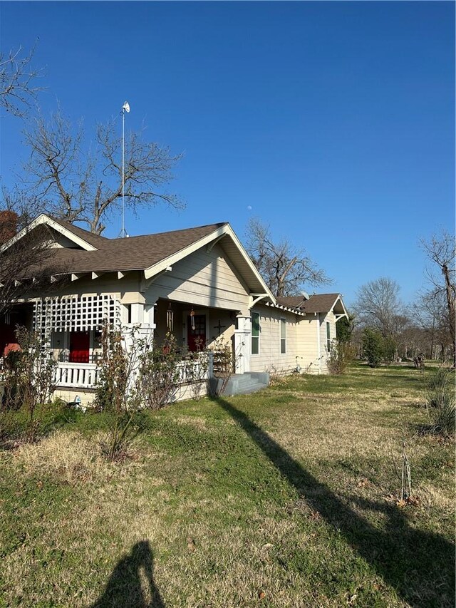 exterior space featuring a lawn and a porch