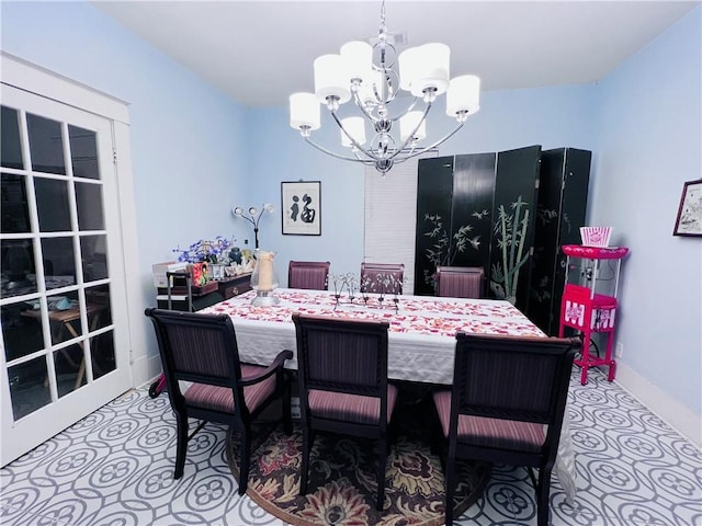 dining area with an inviting chandelier and baseboards