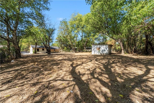 view of yard with a storage unit and an outdoor structure
