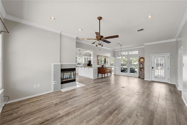 301 Whispering Meadows Dr, Hewitt, TX 76643 - unfurnished living room featuring a ceiling fan, wood finished floors, recessed lighting, crown molding, and baseboards