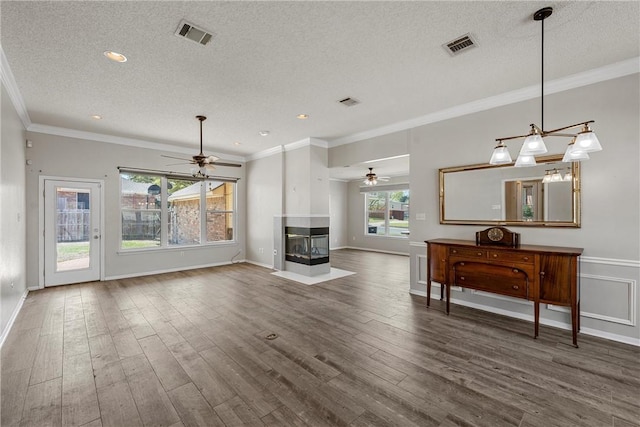 301 Whispering Meadows Dr, Hewitt, TX 76643 - living room with a ceiling fan, a textured ceiling, wood finished floors, a multi sided fireplace, and baseboards